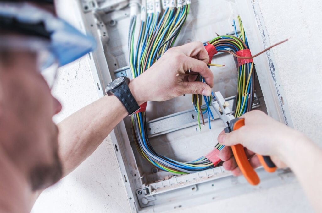 Professional electrician installing wiring in Winnipeg home