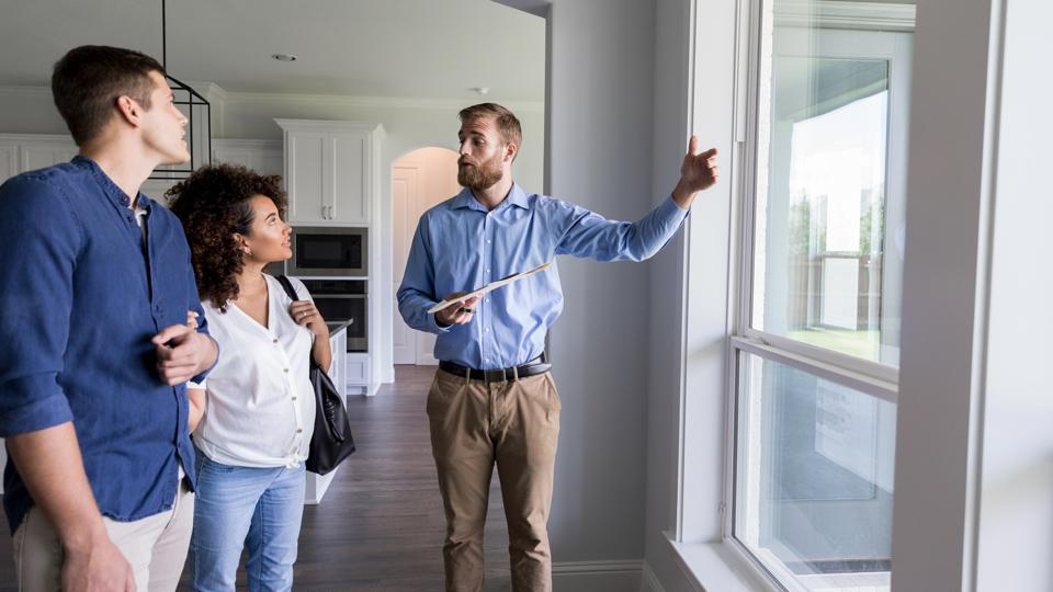 Accsell Realty agent showing a home to clients