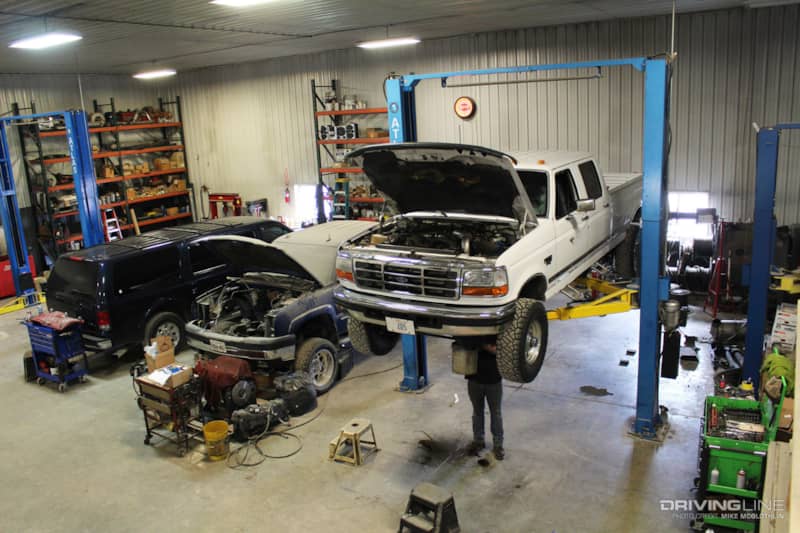 Professional mechanic working on a diesel truck in a modern auto repair shop