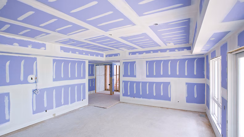 Professional drywall taping in progress