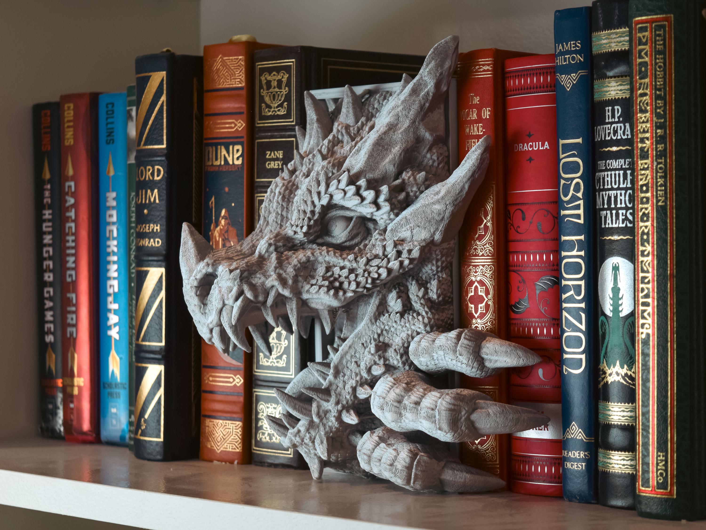 Fantasy book collection with dragon bookend on shelf at Bakka-Phoenix Books