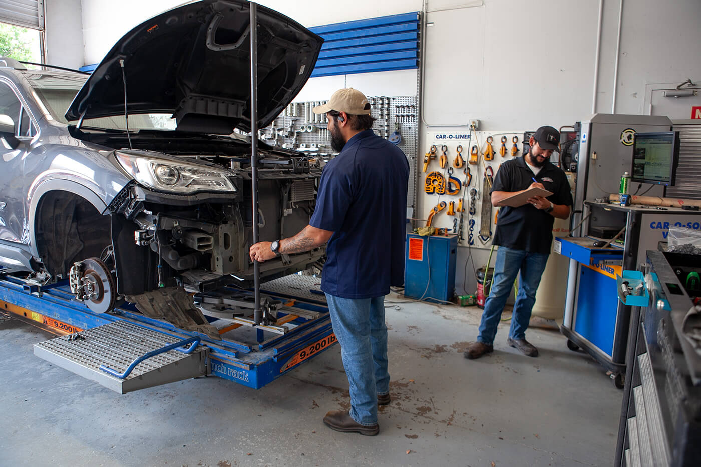 Auto body technicians performing collision repair in Edmonton shop