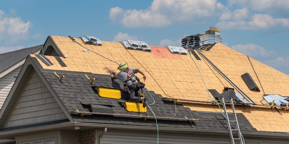 Professional roofer installing shingles on a residential roof in Ottawa