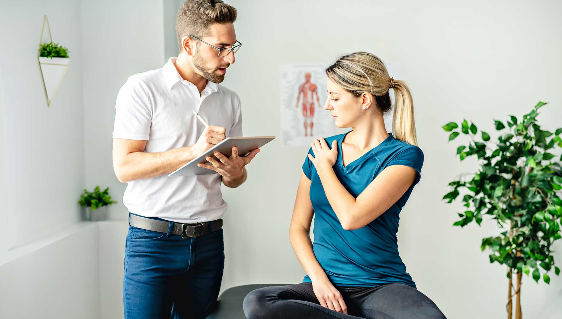 Chiropractor consulting with patient about care