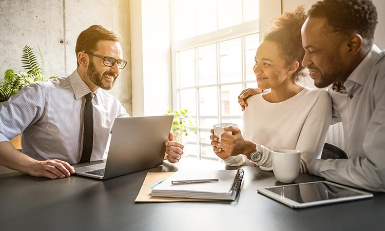 Professional accountant consulting with clients in Calgary office