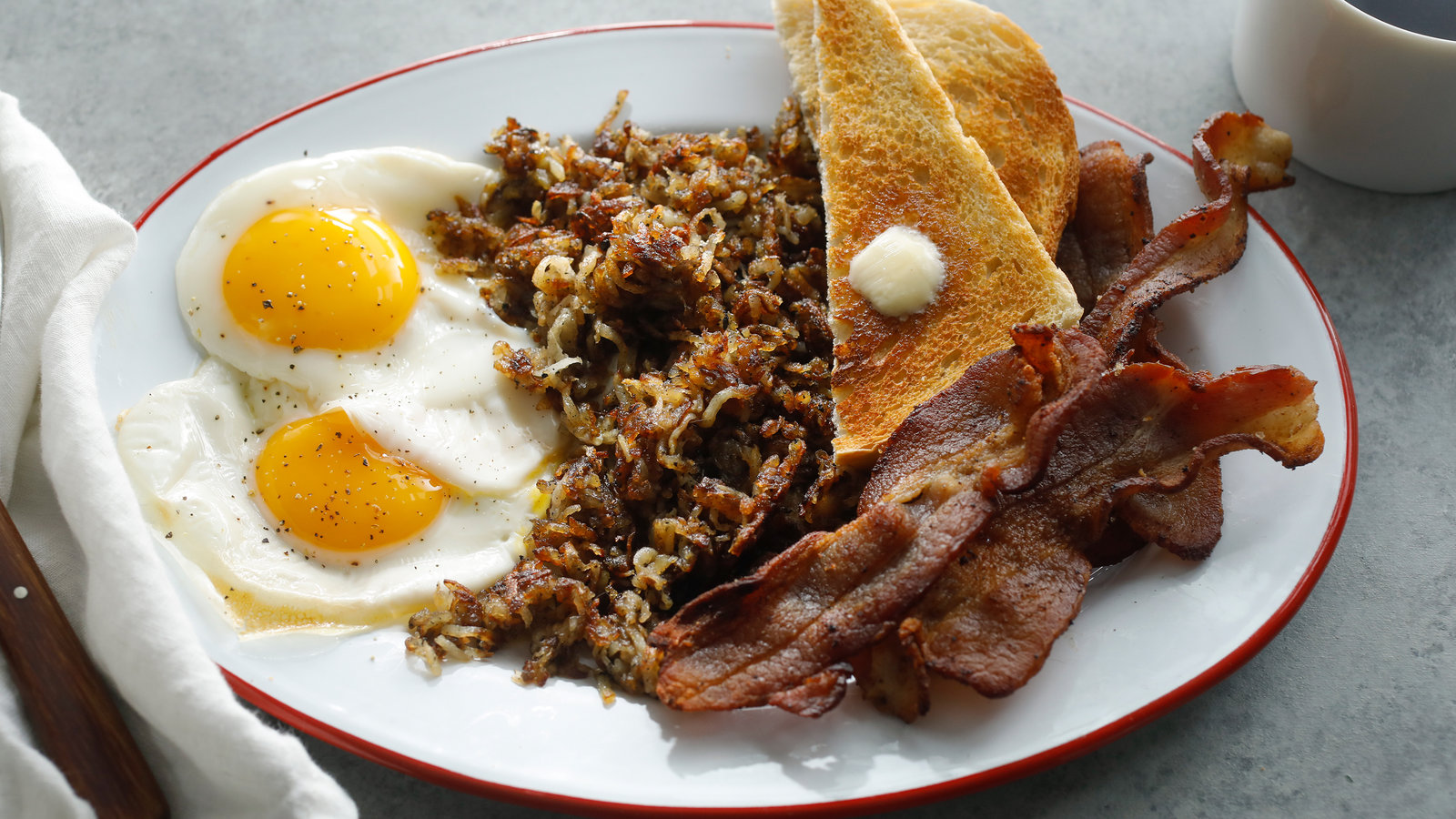 Classic all-day breakfast plate with eggs, bacon, hash browns and toast at Bon's Off Broadway