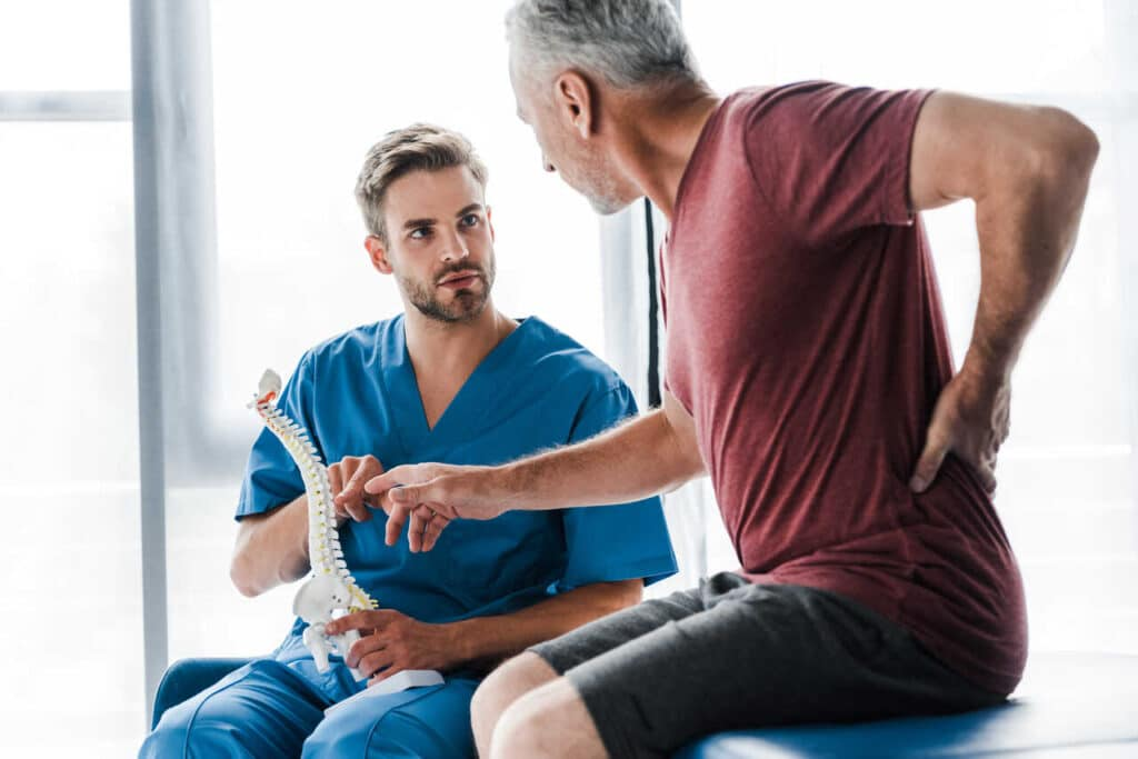 Dr. Paul Brezzi explaining spinal anatomy to a patient