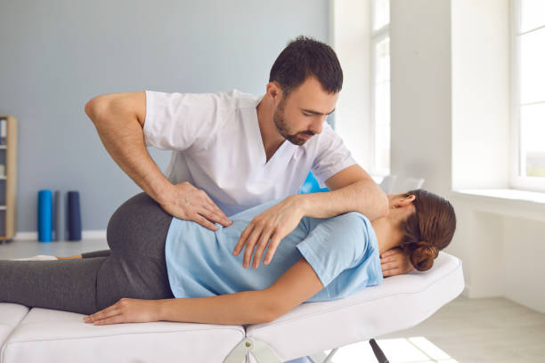 Dr. Paul Brezzi performing a chiropractic spinal adjustment on a patient