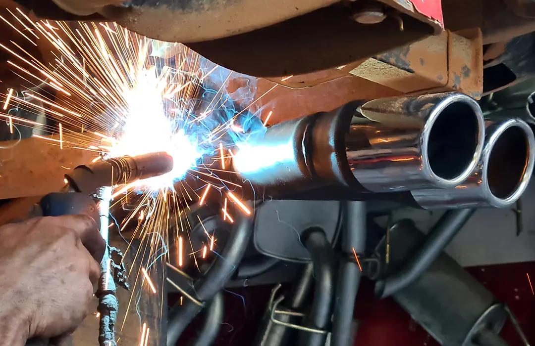 Mechanic working on muffler repair