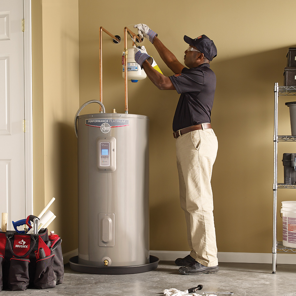 Professional plumber installing a hot water tank