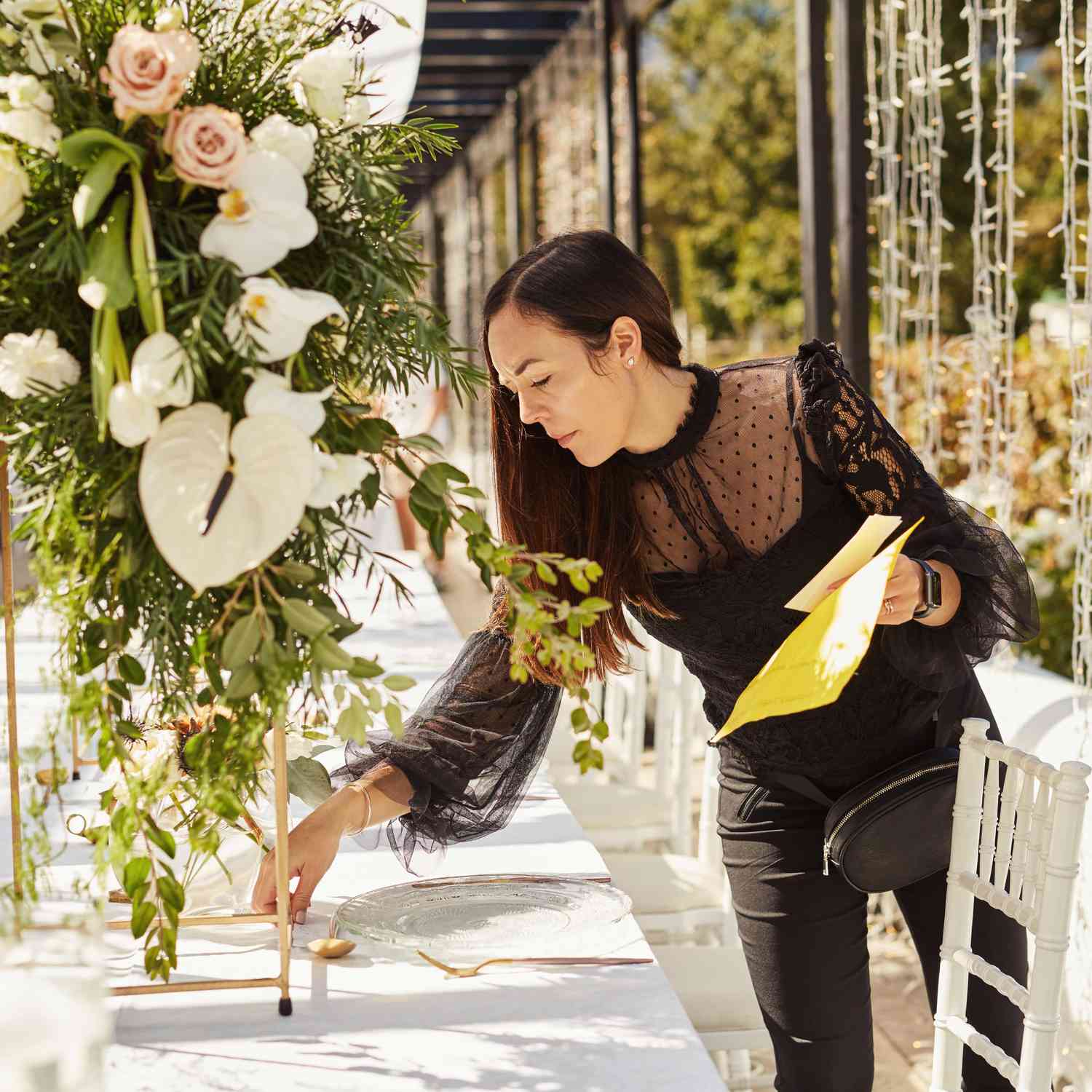 Professional event planner arranging elegant wedding table settings