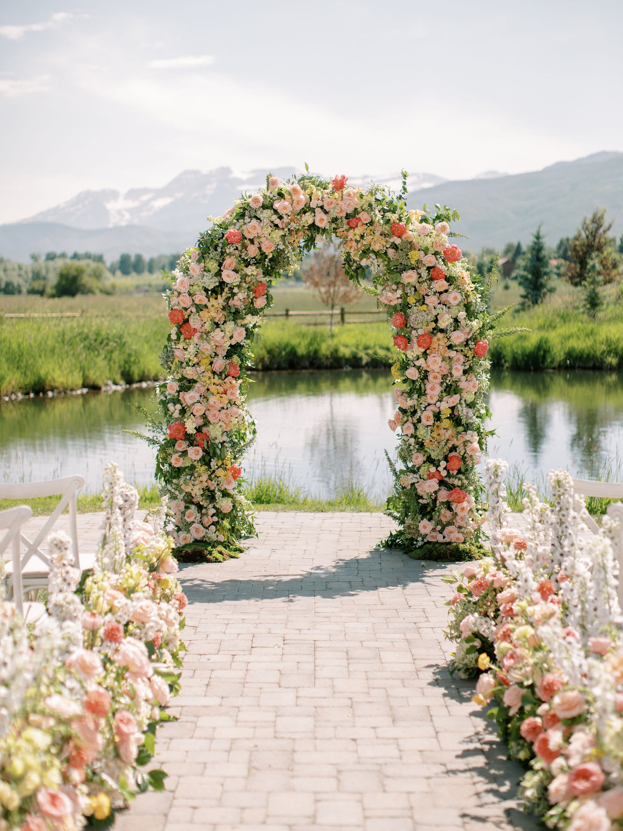 Romantic floral wedding arch by the water