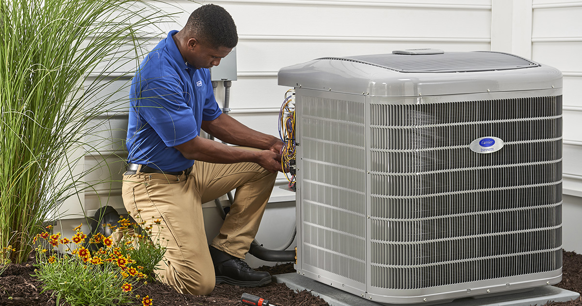 Ambassador Dearie HVAC technician installing air conditioning unit
