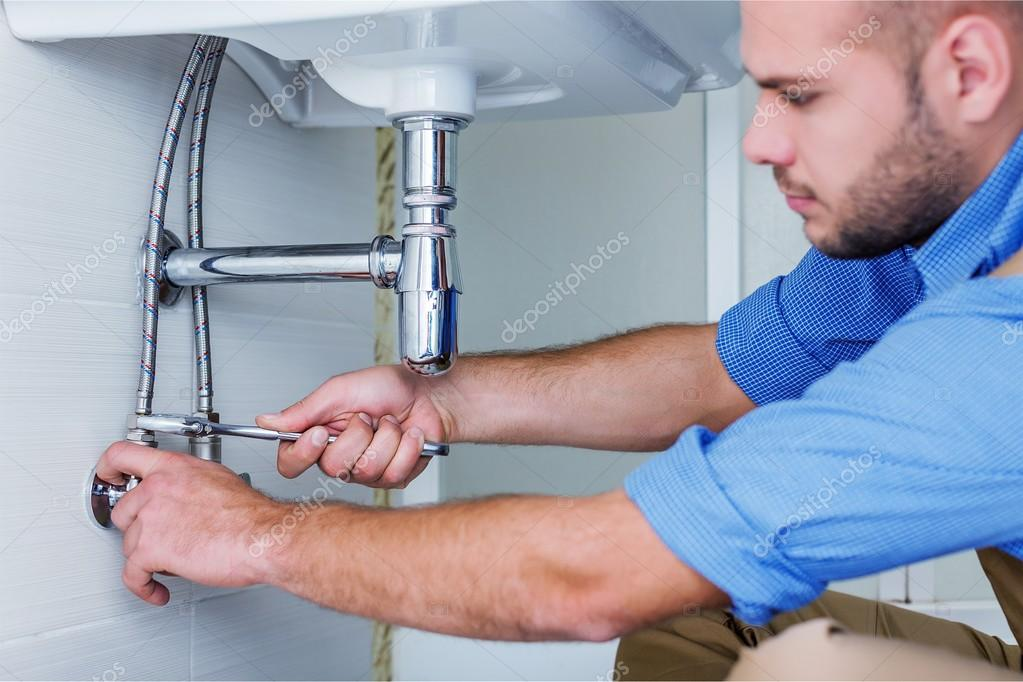 Licensed Eco Star plumber fixing pipes under sink