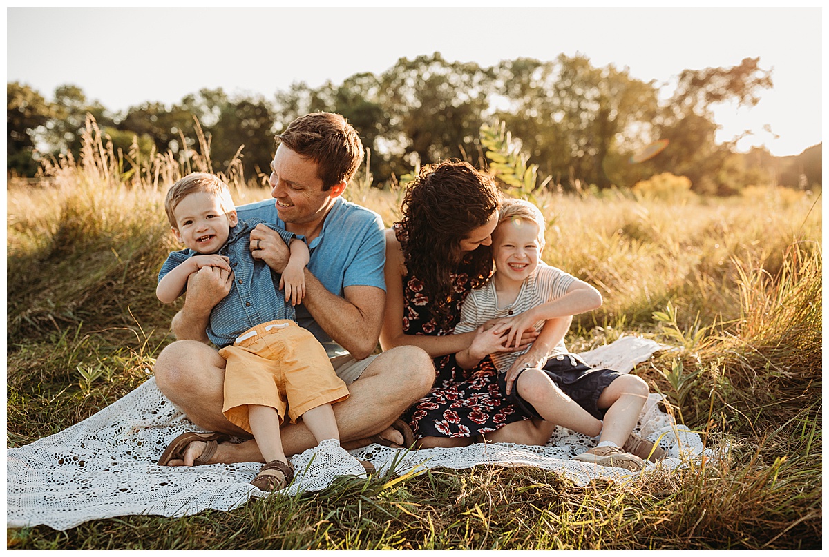 Happy family portrait during golden hour outdoor session