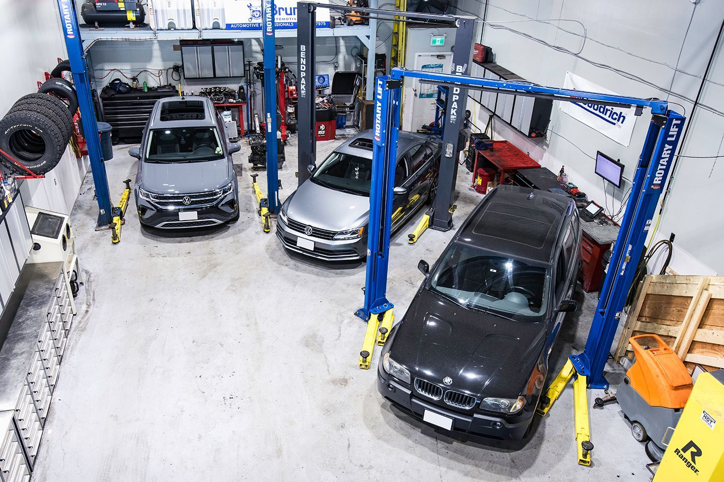 Professional auto repair shop with cars on hydraulic lifts in Vancouver