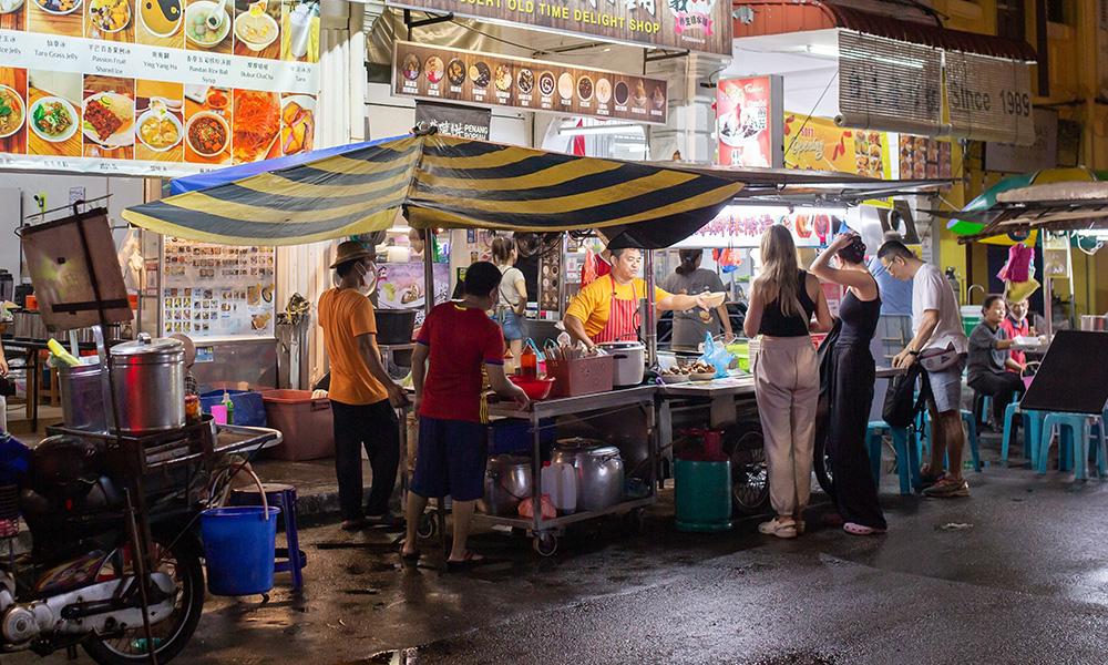 Authentic Asian hawker food stall with people ordering street food