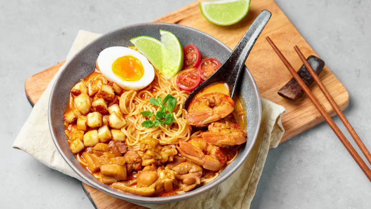 Bowl of Malaysian laksa with shrimp, egg, and noodles