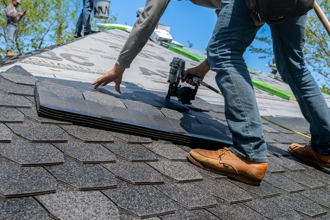 Professional roofer installing shingles on a residential roof in Winnipeg