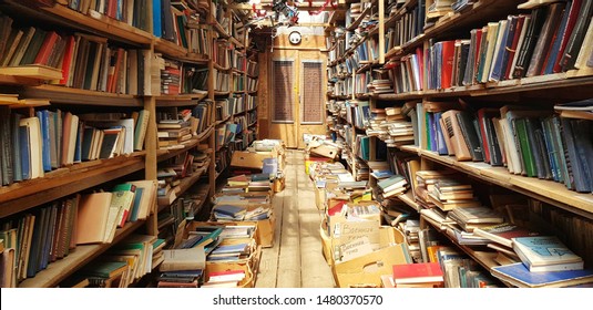 Massive used bookstore with towering shelves of vintage books