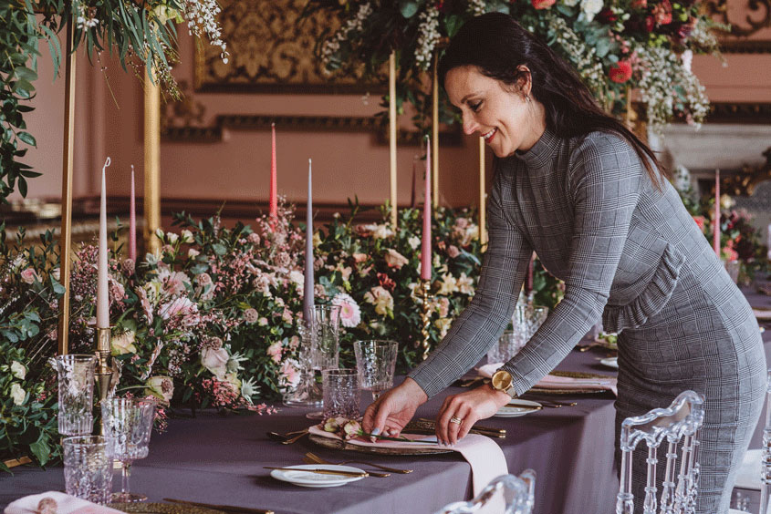 Kennedy Event Planning team styling an elegant wedding table