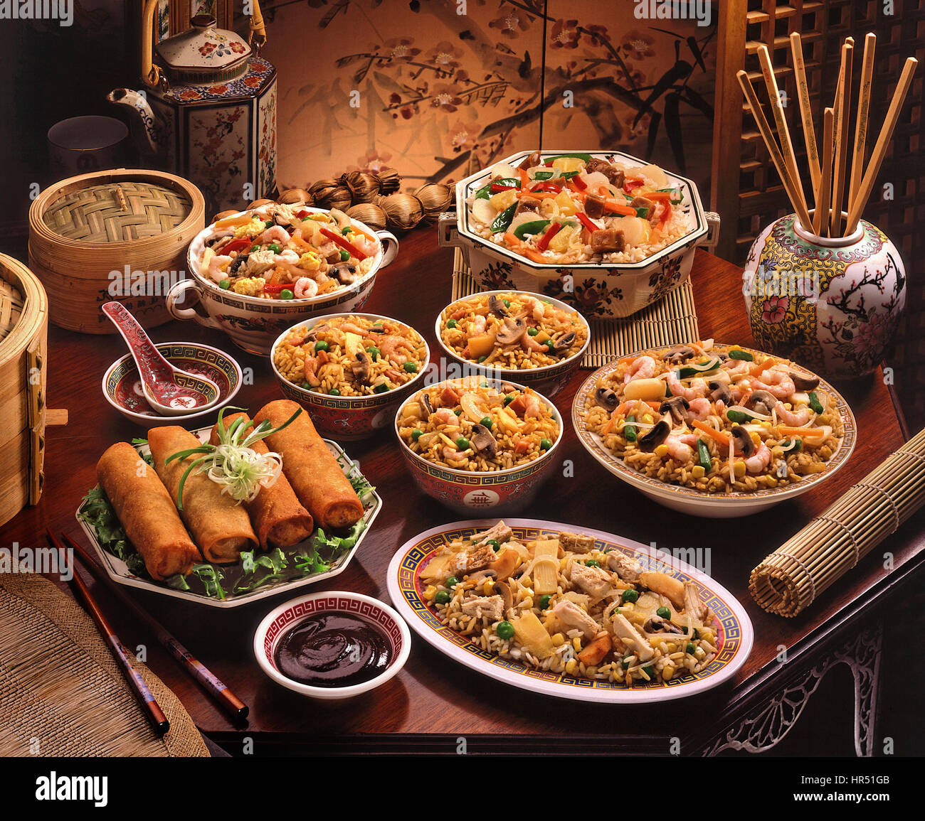 Traditional Chinese banquet spread with multiple dishes on a wooden table