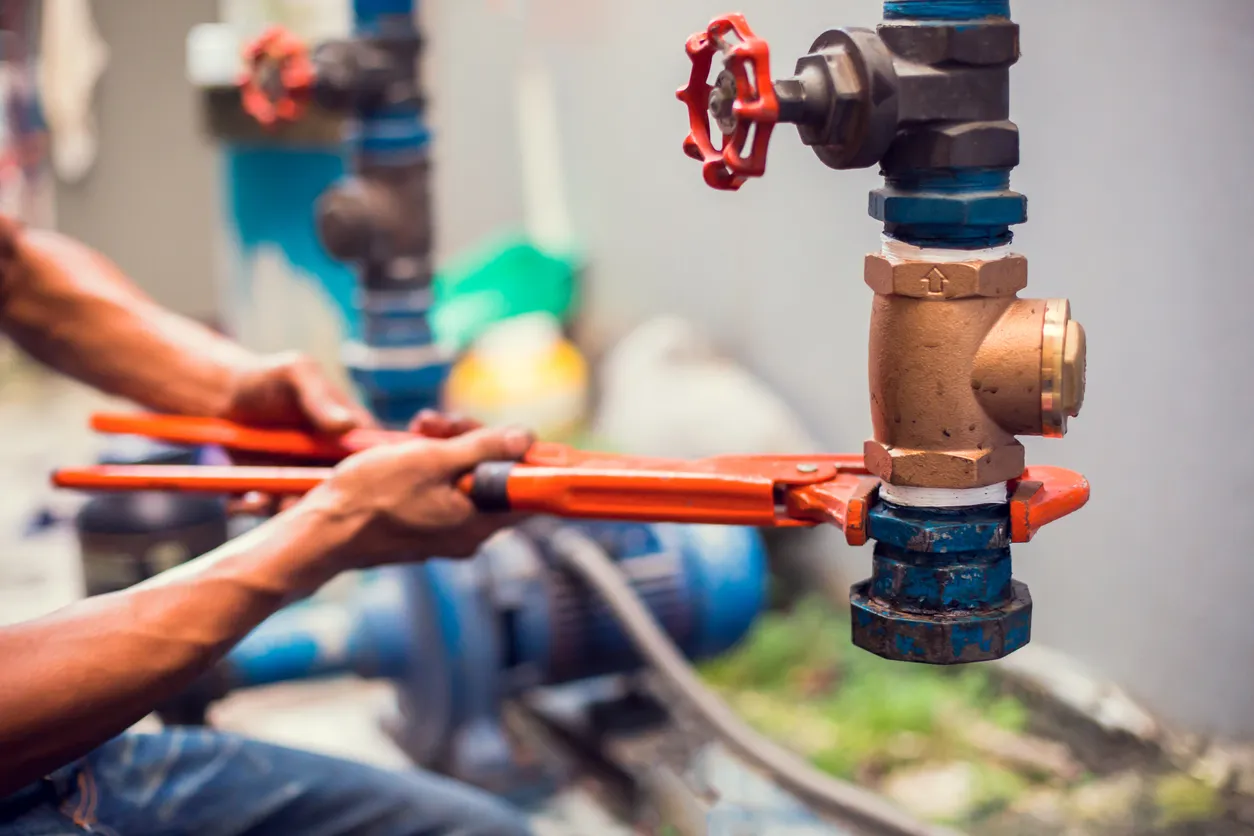 Professional plumber working on commercial pipes in Edmonton
