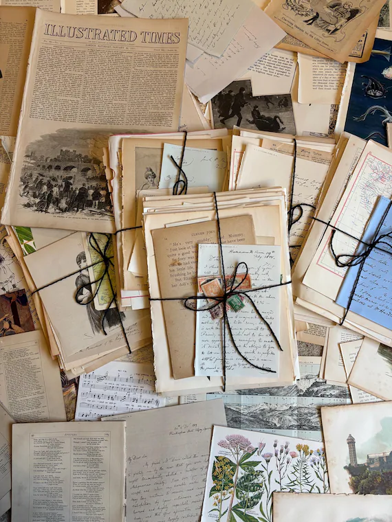 Vintage ephemera collection featuring antique letters, prints, and paper curiosities