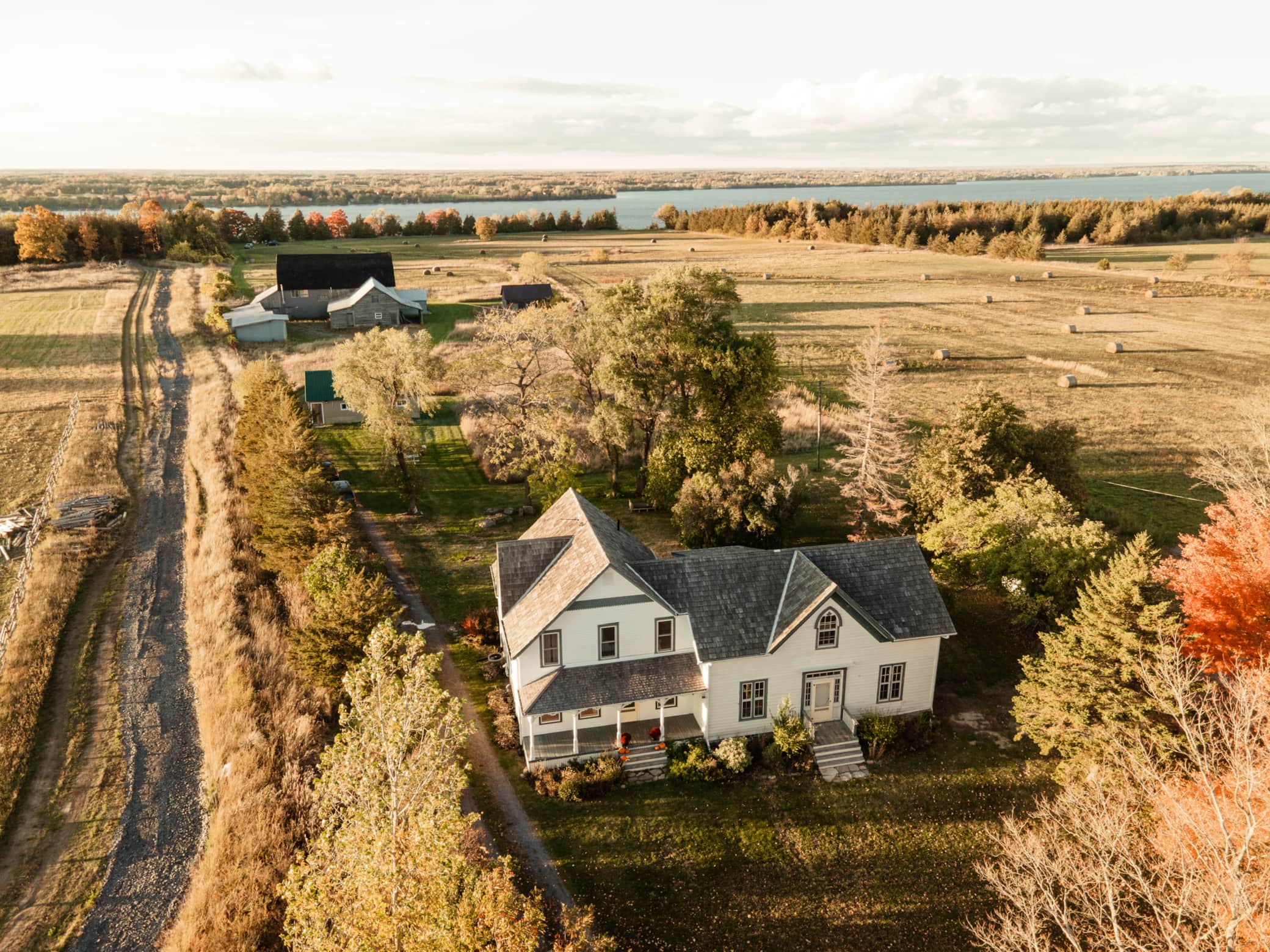 Aerial view of a beautiful rural Ontario farmhouse with surrounding farmland