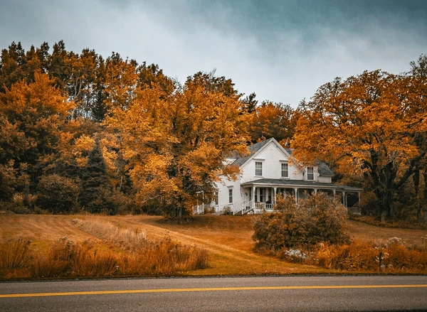 Beautiful rural Ontario farmhouse surrounded by autumn trees