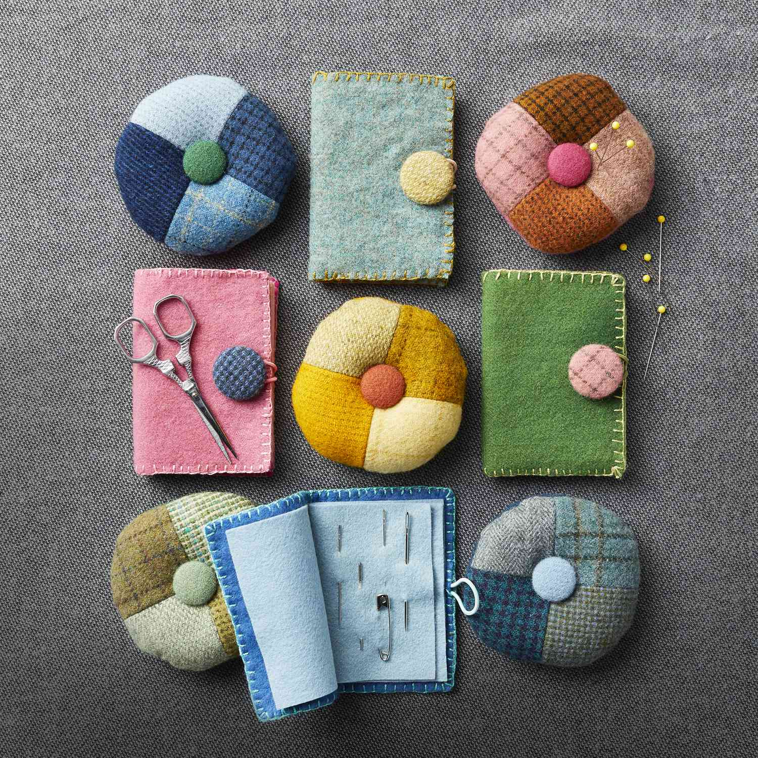 Colorful handcrafted felted wool projects laid out on a table