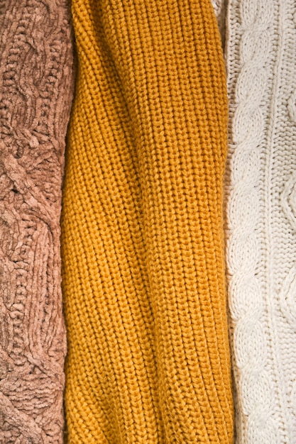 Hand-knit wool sweaters in warm autumn colours