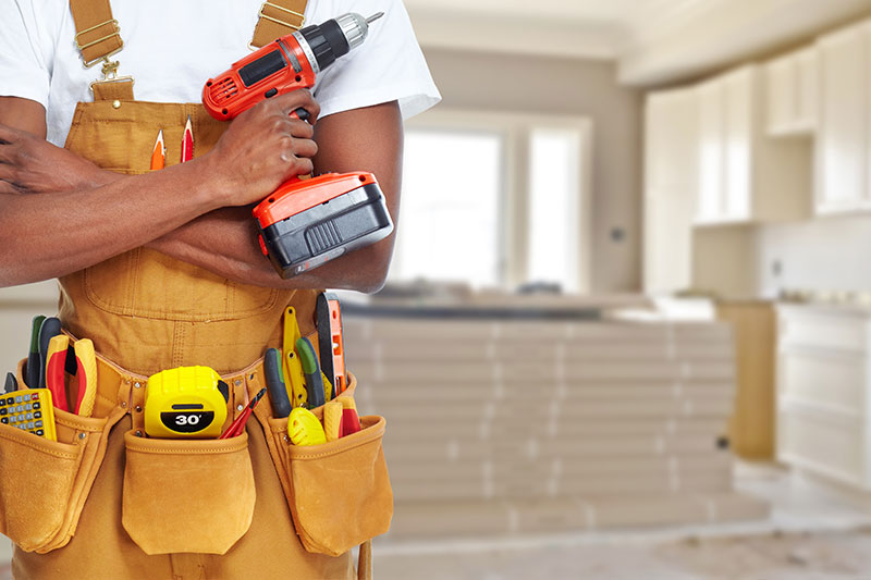 Professional handyman with toolbelt ready for home renovation
