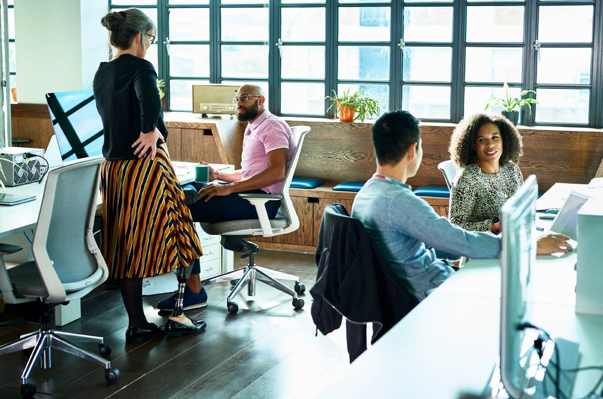 Diverse communications professionals collaborating in a modern office environment