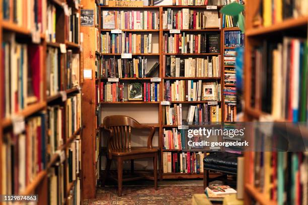 Cozy reading nook inside Russell Books with floor-to-ceiling shelves