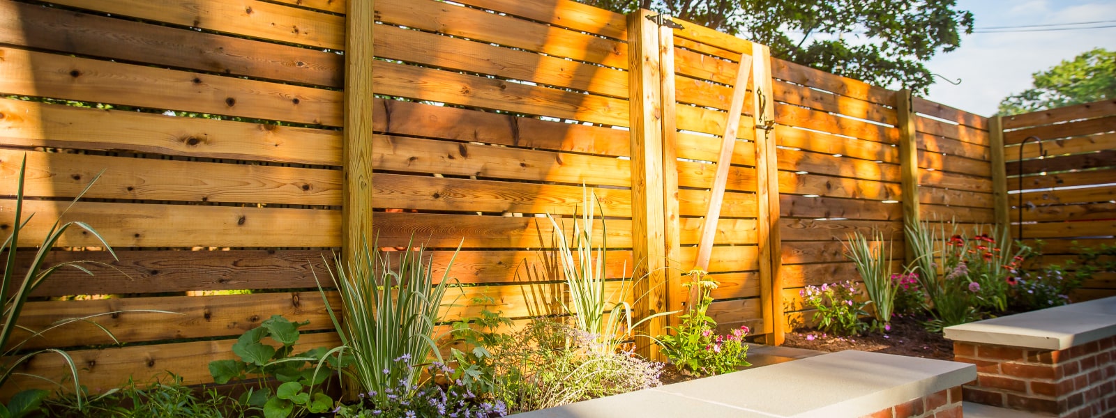 Beautiful custom wood fence with landscaping