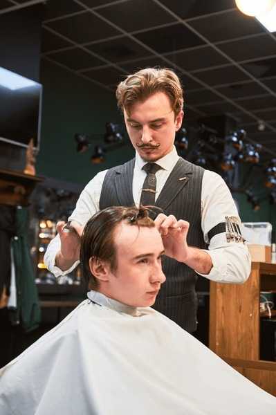 Professional barber giving a precision haircut