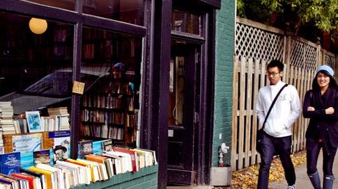 The Word Bookstore exterior on a tree-lined street in Montreal