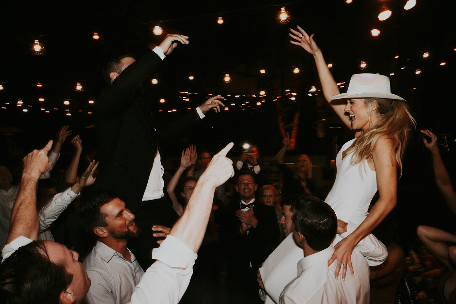 Wedding reception dance floor with guests celebrating
